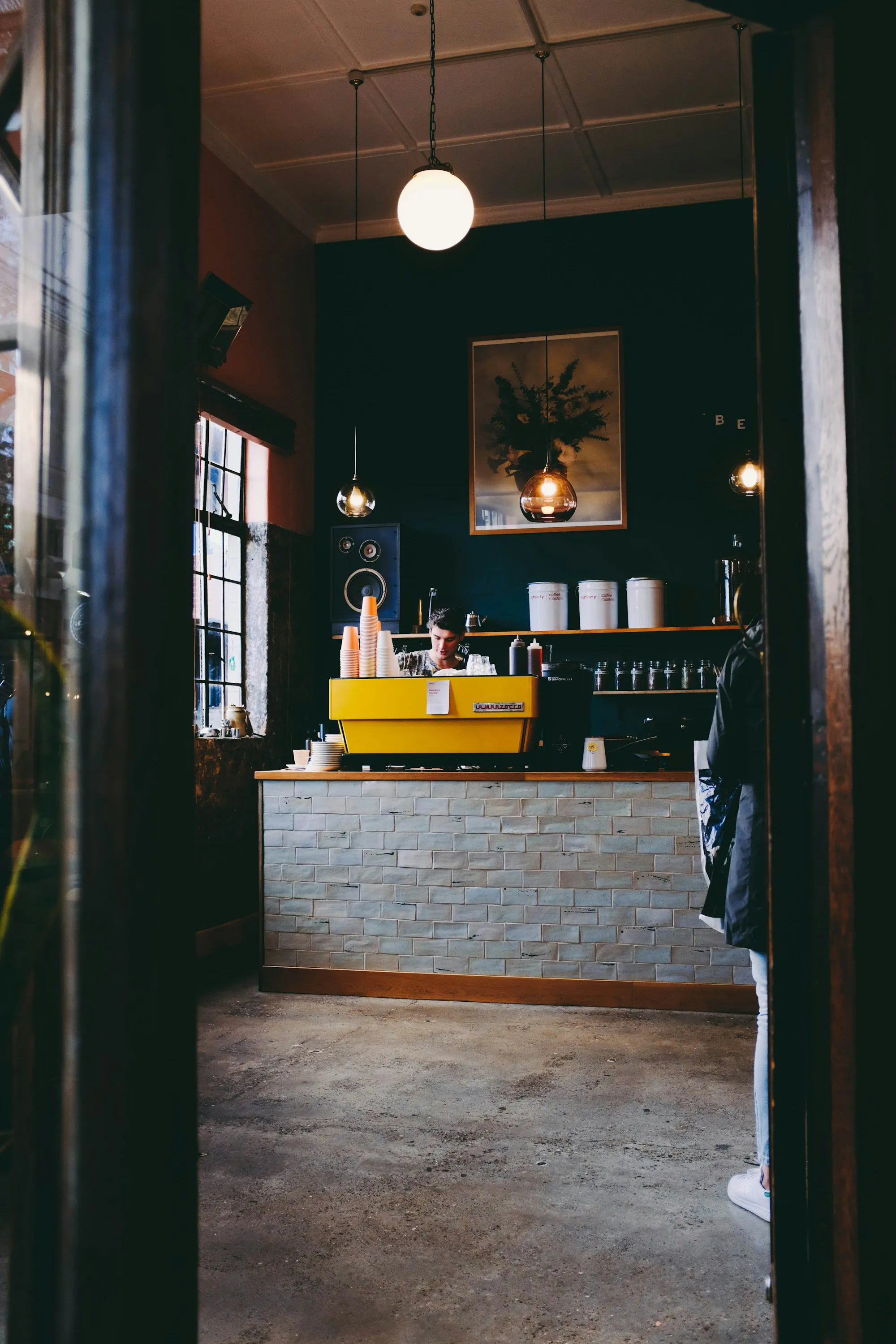 A yellow espresso machine on the counter of an Auckland café