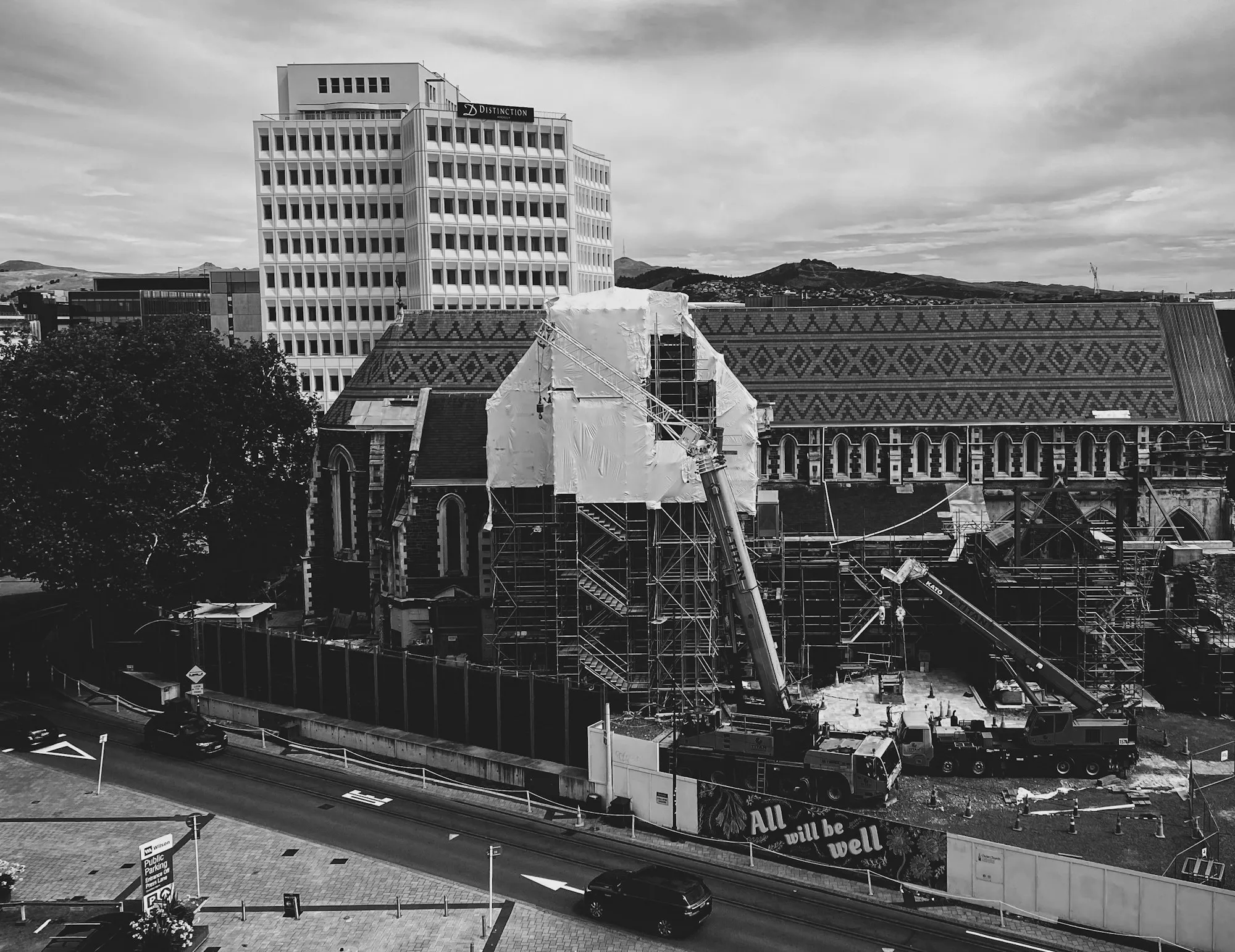 Black-and-white view of scaffolding around a building under repair in Christchurch