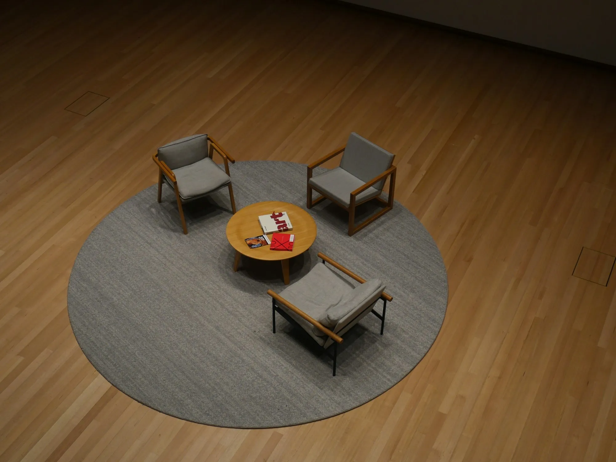 Chairs around a low coffee table on a timber floor in Wellington